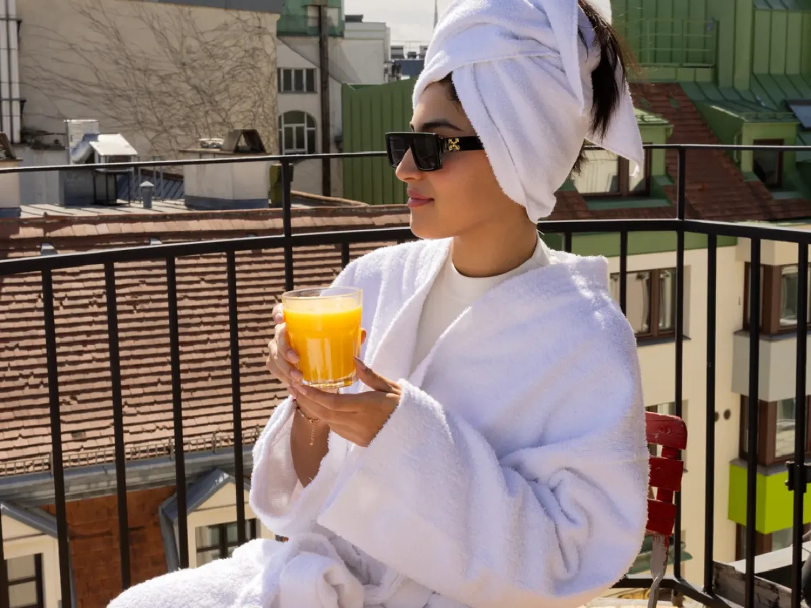 Guest relaxing on the Rose Studio balcony